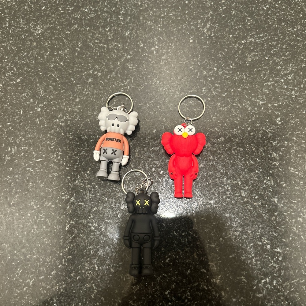 Set of Three Kaws Keychains - Red, Gray, Black